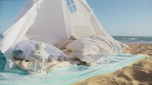 阳光明媚的夏日落日 海滩上的白色帆布帐篷 暑假和假日背景 在蓝天上有复制空间 浪漫的约会和婚前的背景 用红色相机拍摄慢镜头 — 图库视频影像