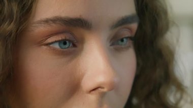 Side view light blue eyeball iris. Fashion girl slow motion on RED camera. Macro shot of light green eyes of young beautiful woman. Good vision, I see you, The eye is the mirror to ones soul concept