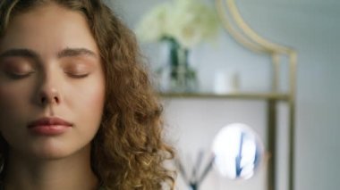 Portrait of young green eyed woman looking up with serious confident face expression in modern bright apartment with day light. Beauty copy background. Slow motion real people 4K footage RED camera