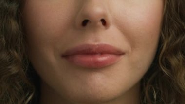 Young female with healthy skin and beautiful white teeth smiling cheerfully. Macro background of pink lips. Expressive emotional fun and joy lifestyle concept 4K. Happy Smiling People Close up Concept