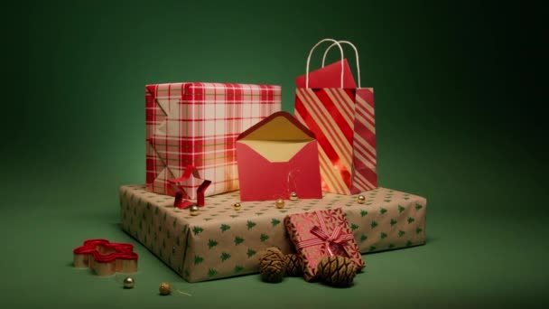 魔法のクリスマスの夜 家族の愛と世話の概念 カード用の封筒を開けました 赤と黄金のカラーギフトラップ4K 緑の背景に隔離されたクリスマスと新年の贈り物の美しいスタック — ストック動画