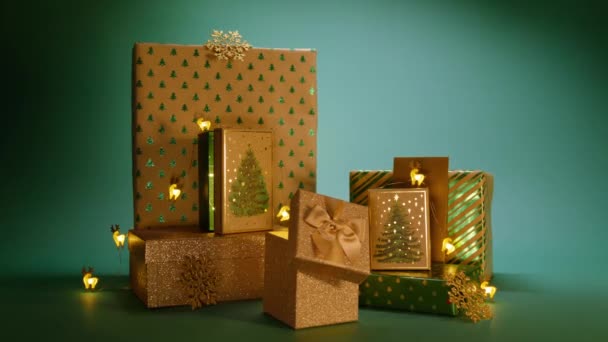 圣诞节的夜晚 神奇的圣诞光在一堆堆礼物中轻轻滑行 新年派对 全家人都爱红色4K 快乐2024新年明信片概念背景 绿色背景礼品盒 — 图库视频影像