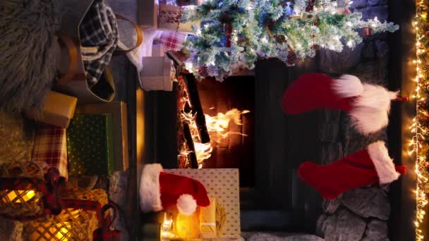 用燃烧的火焰和闪光的照明代替垂直视图 舒适的圣诞和新年室内装饰4K 可重复使用的圣诞树 装饰有玩具 礼品盒和轻便的花环 — 图库视频影像