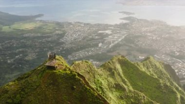 Haiku merdivenlerinin üstündeki hava manzarası. Oahu adasında turistik bir yer. Dik yamaçlı destansı yeşil dağ zirveleri Oahu Adası, Hawaii 'deki Cennet Merdiveni' nin 4K 'lık dramatik manzarası.