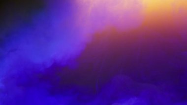 Blue cloud of paint filling colorful background underwater. Closeup of ink drop falling in water. Blue liquid flowing on surface in slow motion. Colorful smoke animation, 4k footage with copy space