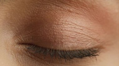 Macro close up shot of female human eye. Young woman with incredible light green eyes. Close up shot of eye opening with beautiful teal iris. Healthy eyesight concept. Front view 4K RED camera footage