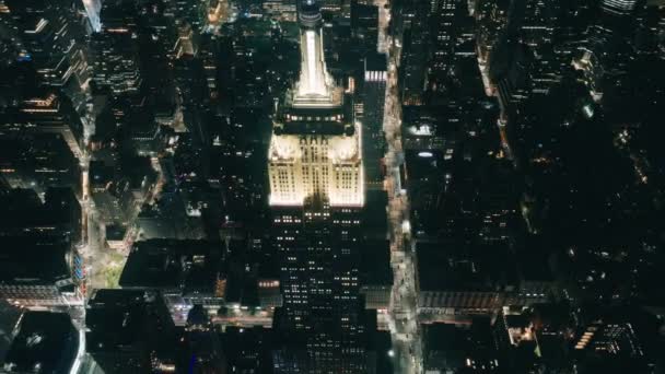 Aerial Dolly Shot Empire State Building Manhattan Night Surrounded Skyscrapers — Stock Video