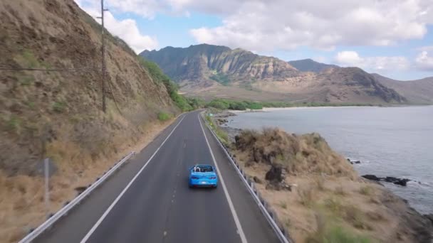 Aerial View Blue Convertible Car Driving Coastal Road Dramatic Rocky — Stock Video