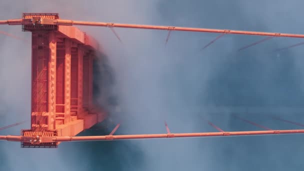 在迷雾中交通拥挤的道路上的近景 夕阳西下 金门大桥的红色塔楼上 云彩斑斓 令人眼花缭乱 旧金山金门大桥旁边汽车的头顶天线 — 图库视频影像