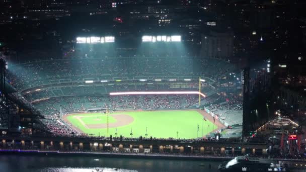 オラクルパーク サンフランシスコ カリフォルニア 2023年7月3日 大きなスポットライトで照らされた野球ファンのスポーツフィールドがいっぱいです スポーツアリーナでの野球ゲーム 夜遅くのダウンタウンのオラクルパークの上空 — ストック動画