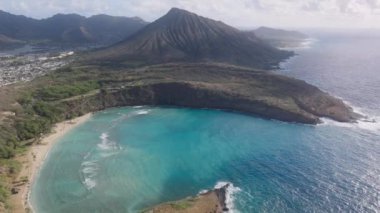 Volkan kraterinde mercan resifi olan tropik bir ada. Hawaii adasındaki Hanauma Körfezi Doğa Koruma Alanı 'nın havadan görünüşü. Koko volkanı krater manzarası. Deniz mavisi su renginde okyanus koyunun doğası.