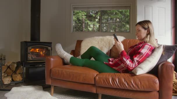 Eine Junge Frau Liest Nachrichten Auf Dem Handy Und Entspannt — Stockvideo