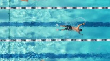 Etkileyici bir 4K görüntüsü, güneşin doğuşunda havuzda yüzen bir yüzücüyü gösteriyor. Yavaş çekimde zarifçe yüzüyor, sakin vuruşlarını vurguluyor.