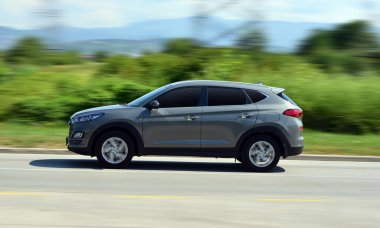 A large SUV is moving at high speed