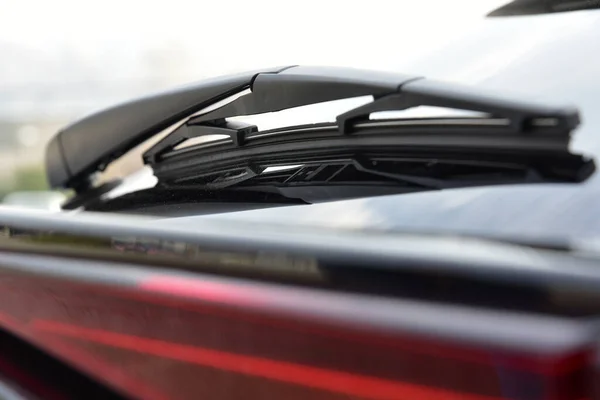 stock image Wiper on the back windshield of a passenger car with reflex and with blur