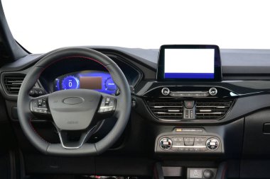 Passenger car dashboard with steering wheel, instrument panel and infotainment display