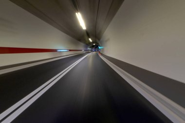 Driving at high speed in a tunnel on a highway road. clipart