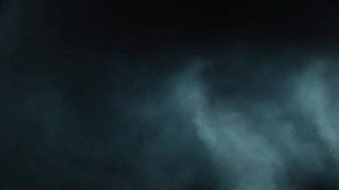 Atmosferik duman VFX elementi 4k ağır çekimde. Belirsiz bir geçmişi var. Toz, duman bulutu. Siyah arka planda duman. Beyaz duman siyah bg üzerinde sürünüyor.