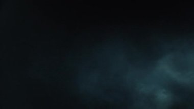 Atmosferik duman VFX elementi 4k ağır çekimde. Belirsiz bir geçmişi var. Toz, duman bulutu. Siyah arka planda duman. Beyaz duman siyah bg üzerinde sürünüyor.