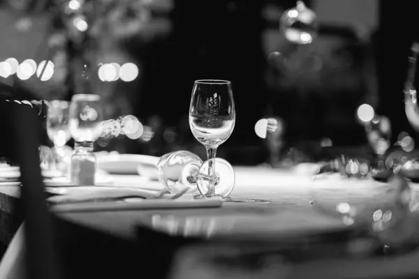 stock image Luxury table settings for fine dining with and glassware, pouring wine to glass. Beautiful blurred background. Preparation for holiday wedding. Fancy luxury restaurant.