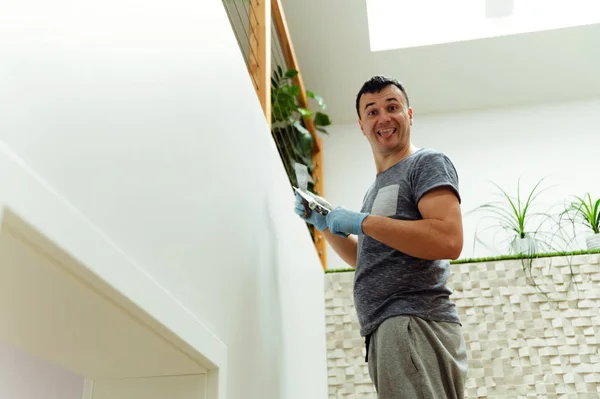 a young man plasters the walls at home during repairs. repair work. handyman. construction.handyman.