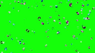 Düşen konfeti yeşil arka planda izole edildi