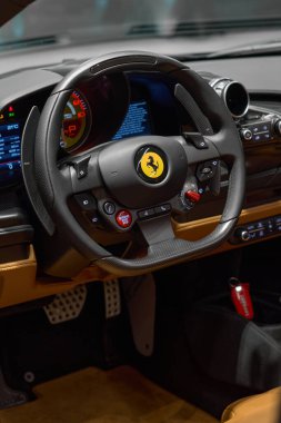 Steering wheel and interior Ferrari F8 Tributo Spider. view through the open door. Katowice, Poland, 29.10.2019