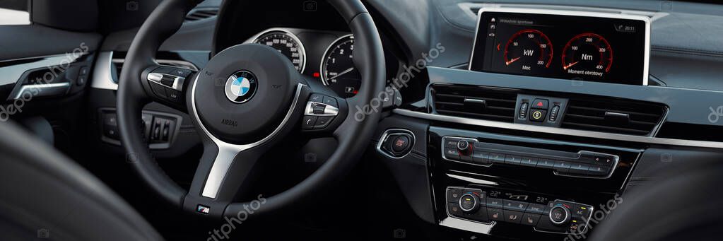 Steering wheel and interior of the BMW X1 in the M Sport version. View from the rear seat. Katowice/Poland, 31.07.2021