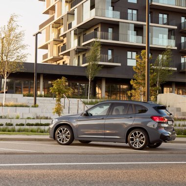 BMW X1 25e, hybrid, plug in car, parked next to a modern building. The total power of both engines is 220HP. Electric range up to 52 km Katowice/Poland- 07.30.2021 clipart