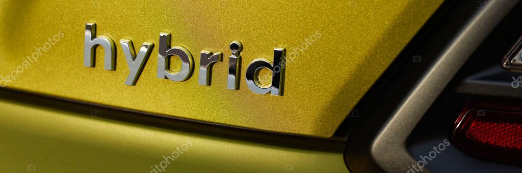 Chromed hybrid car logo on green background