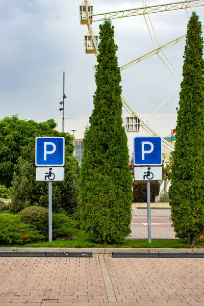 Engelli park yeri, iki boş alan, arka planda dönme dolap.