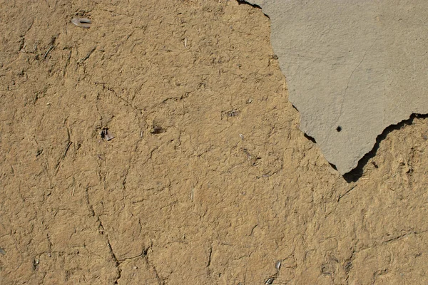 Üzerinde bir parça alçı olan eski bir duvar, boş arkaplan dokusu.