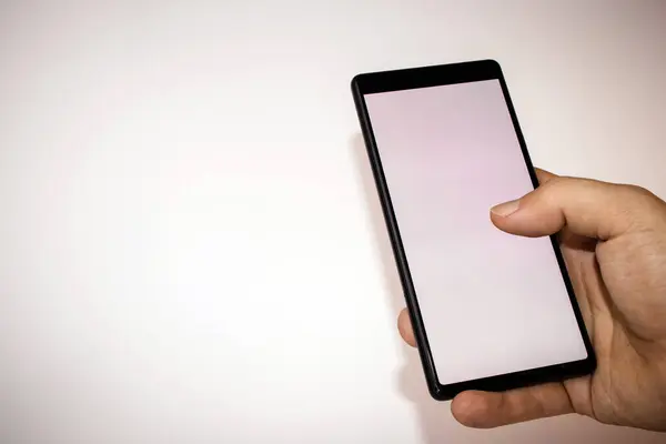 Beyaz arka plan boş ekran ile Smartphone tutan el