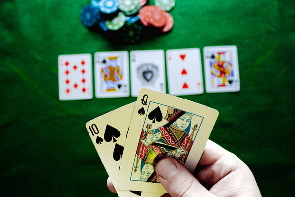 royale flush in Texas hold'em with casino chips on the green table