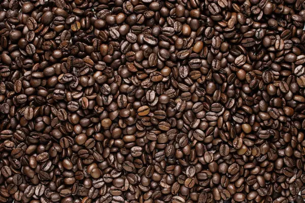 Perfectly roasted coffee beans, brown coffee beans background