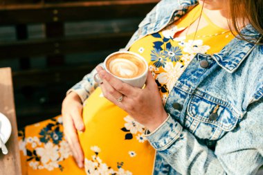 Pregnant woman coffee drink. Lifestyle morning with happy pregnancy girl drink espresso coffee. Represent breakfast, energy, freshness or great aroma concept