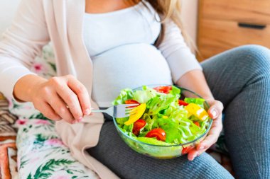 Pregnant salad healthy food. Pregnancy woman eating nutrition diet food salad. Family nutrition, healthy eating concept