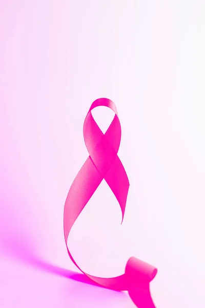 Cancer day. Health care symbol pink ribbon on white background. Breast cancer woman support concept with copy space
