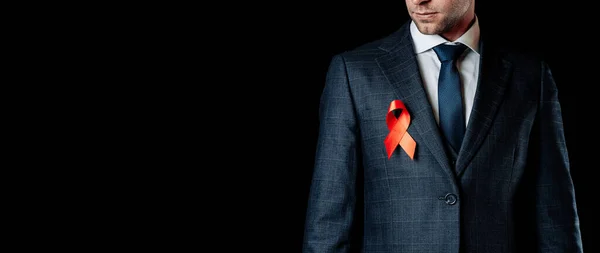 Hiv aids. Red ribbon in hiv world day isolated on dark background. Man holding awareness aids and cancer symbol. Health, Medical sign. copy space