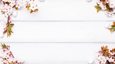 Easter spring background. Sakura flower, white happy easter egg on wooden spring background. Easter wallpaper. Spring holiday concept