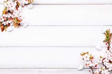 Easter spring background. Sakura flower, white happy easter egg on wooden spring background. Easter wallpaper. Spring holiday concept