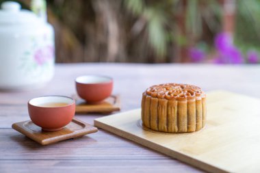 Moon cake served with chinese tea. Mid-autumn festival concept. Copy space.
