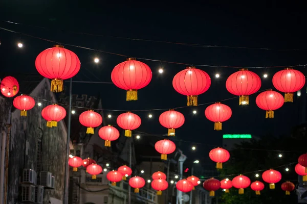 Chinese red lanterns on the street, night time.