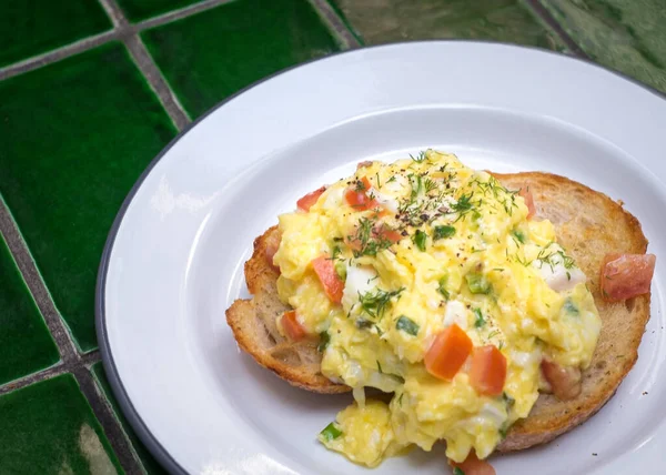 Scrambled eggs on toast bread. Top view.