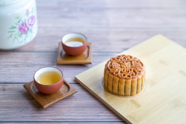Moon cake served with chinese tea. Mid-autumn festival concept. Copy space.