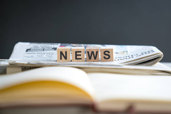 News, word on top of stack of newspaper. Copy space.