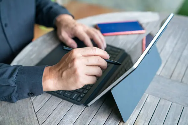 stock image Businessman working on his tablet, close up view. Home environment.