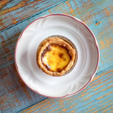 Beyaz tabakta Portekiz yumurtalı turtası. Üst görünüm.