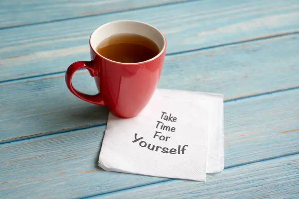 Take time for yourself, words on napkin next to a cup of coffee. Self care concept.
