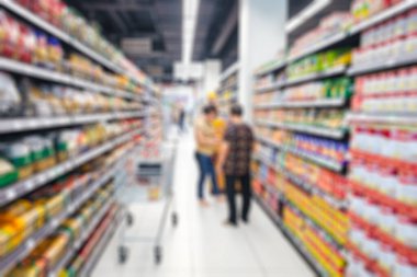 Süpermarket koridorunda, raflarda ürünler ve müşteriler var. Arkaplan için bulanık ya da odaksız.